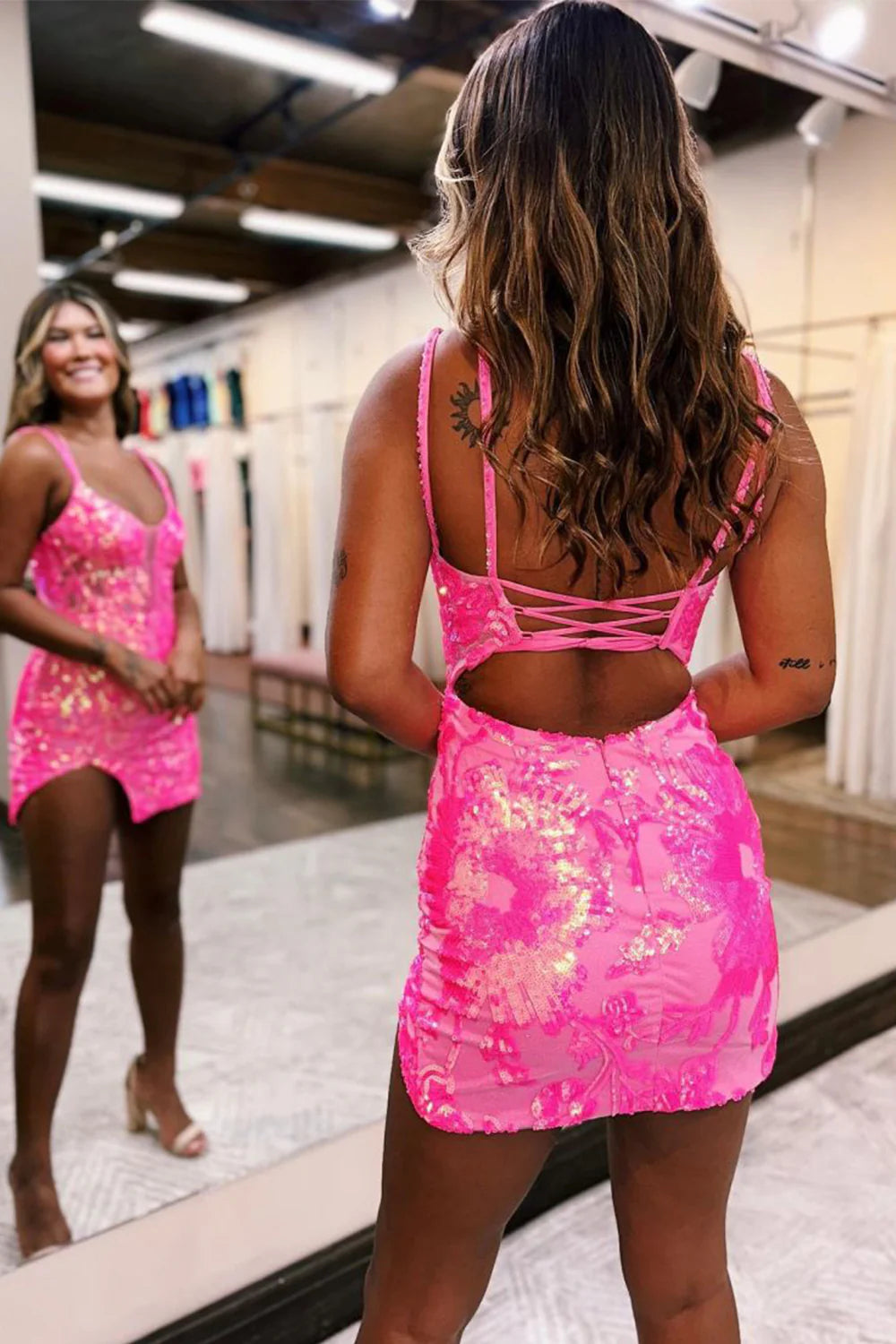 Close-up of the sequined and embroidered details on the short prom dress.