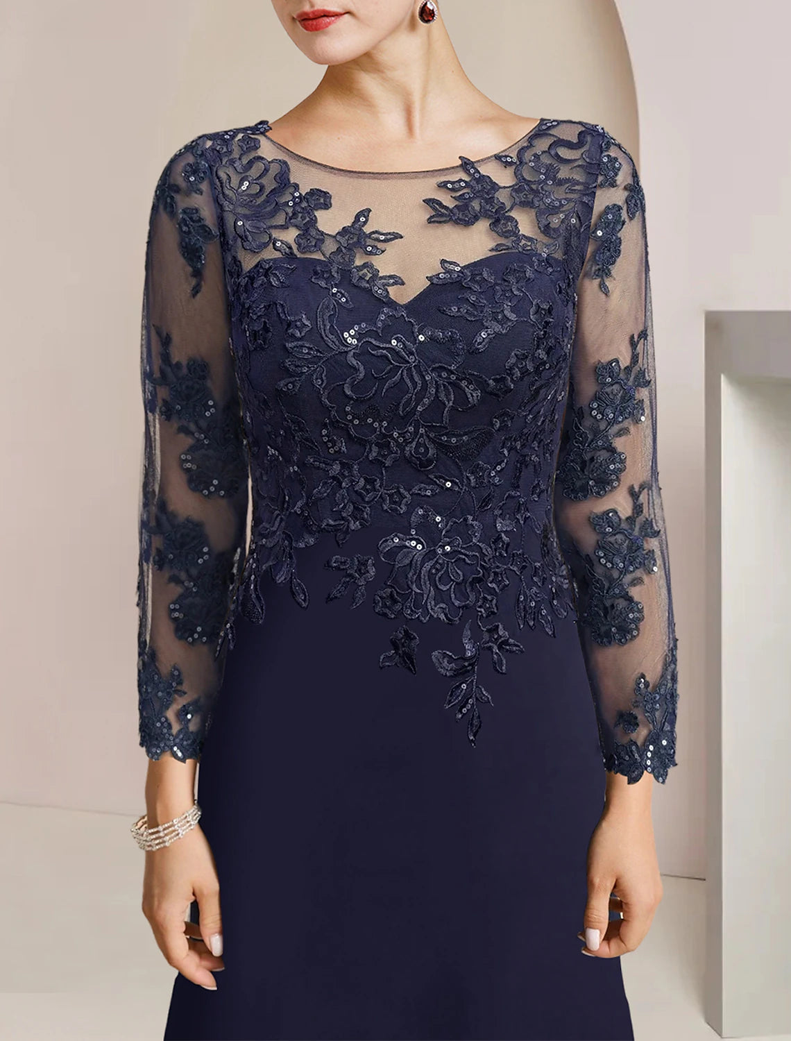 Formal trumpet gown featuring sequin appliques and ruffles, worn by a model.