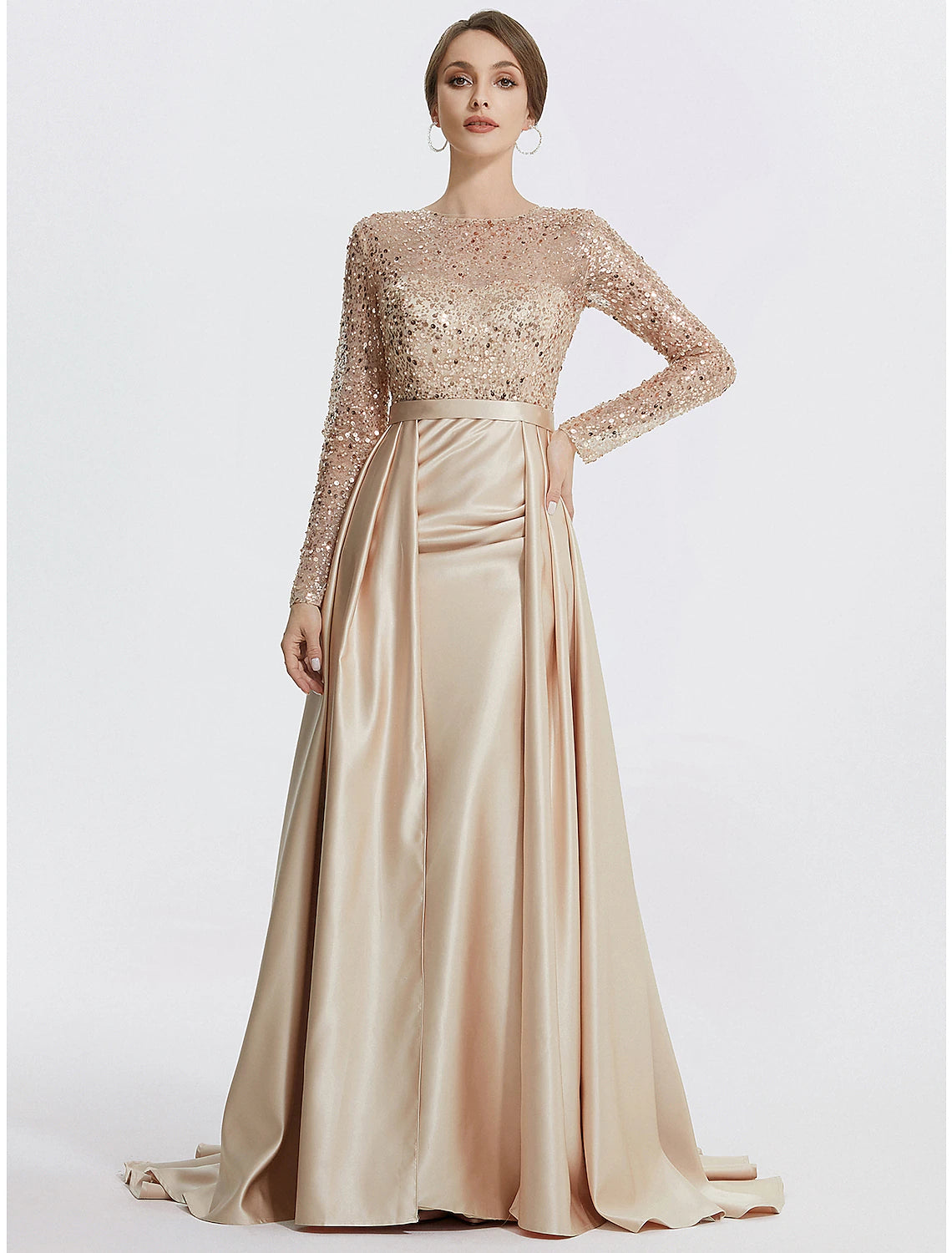 Elegant sequined mermaid trumpet evening gown with long sleeves and jewel neck.