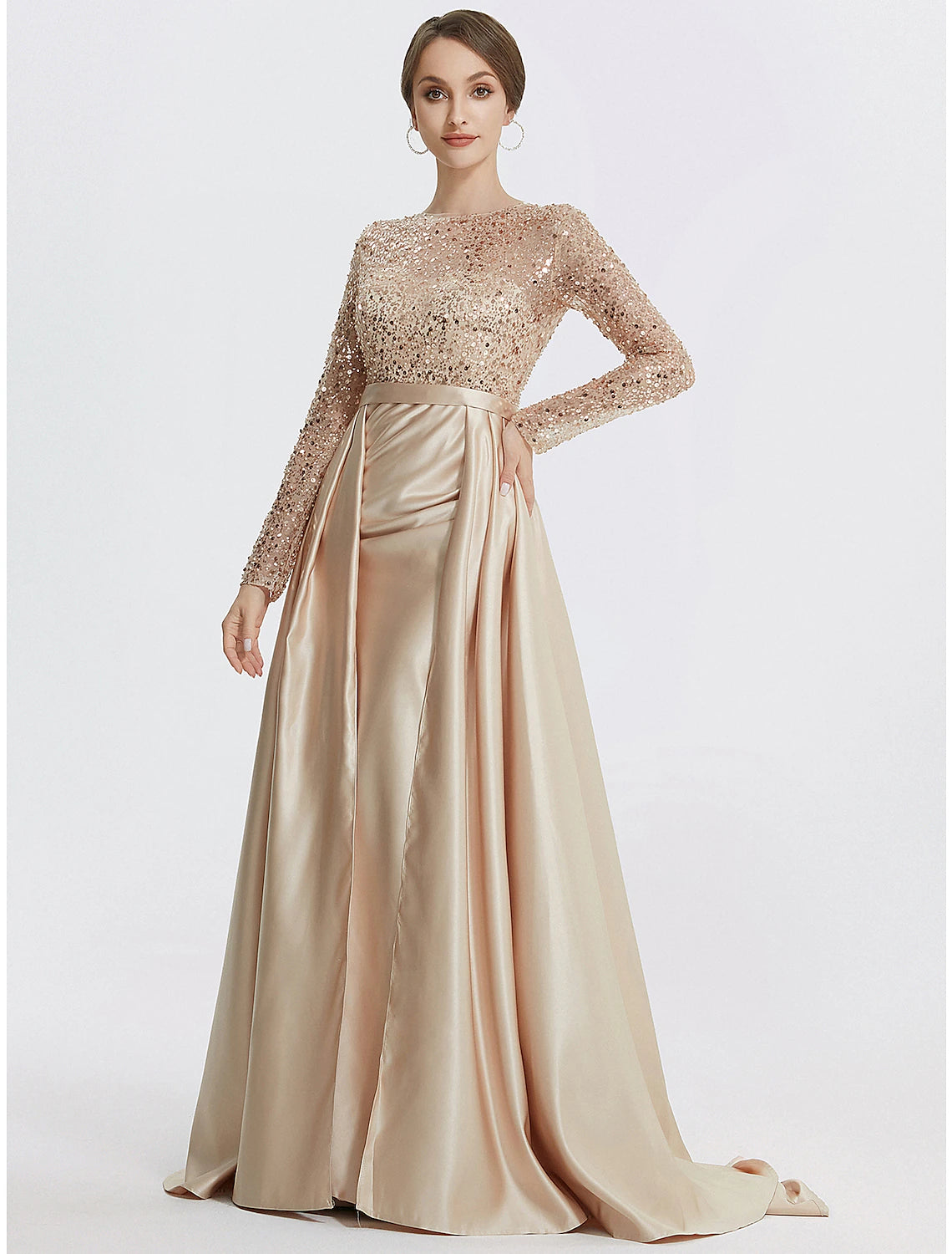 Side profile of a woman wearing the sparkling long sleeve jewel neck evening gown.