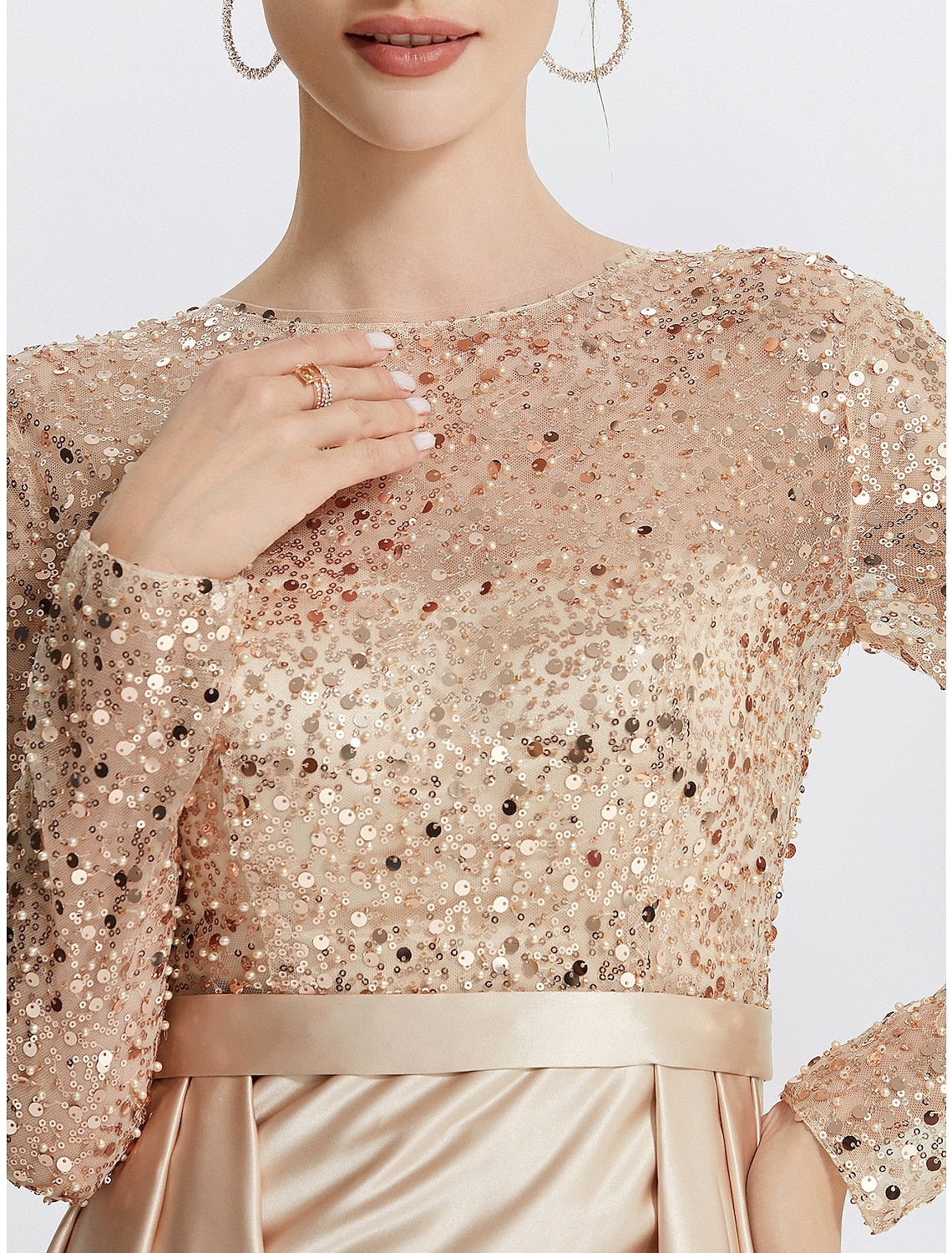 Close-up of the sequin and glitter embellishments on the elegant evening dress.