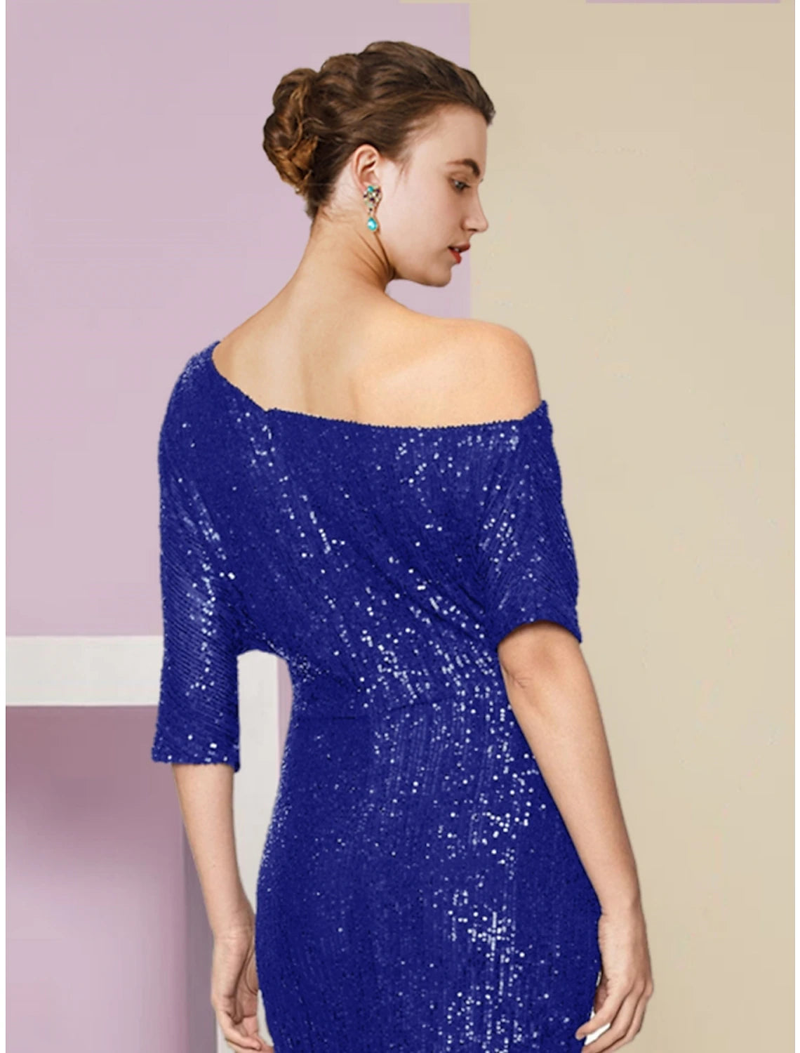 Close-up of the sequined fabric and off-shoulder neckline of the navy blue formal gown.