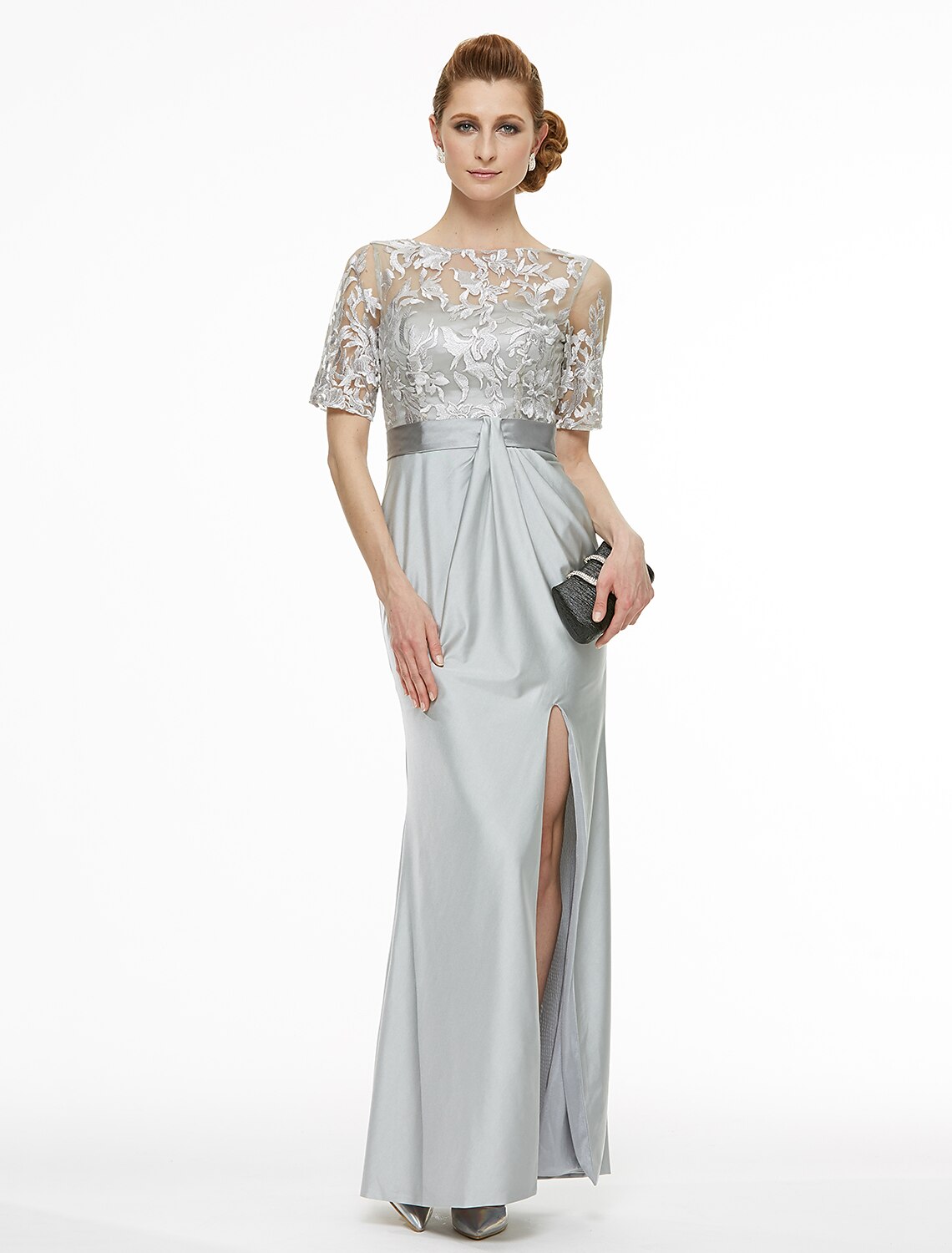 Woman wearing an elegant ankle-length sheath mother of the bride dress with a bateau neck and lace details.