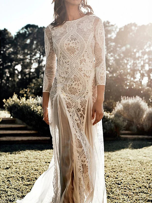 Side view of a bride wearing a sheath wedding dress on the beach.