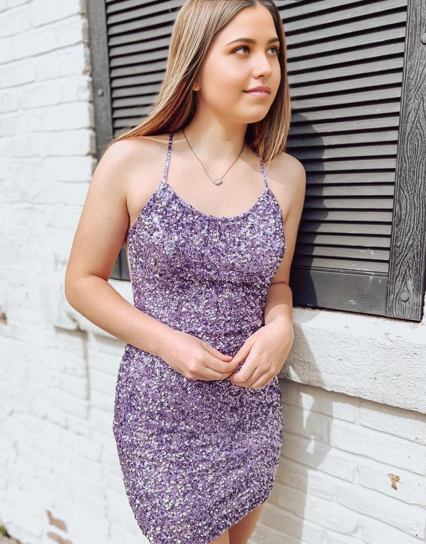 Model wearing a purple sequin sheath bodycon maxi dress with a V-neck and criss-cross back.