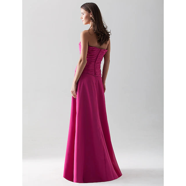 Full-length view of a bridesmaid wearing a strapless chiffon dress.