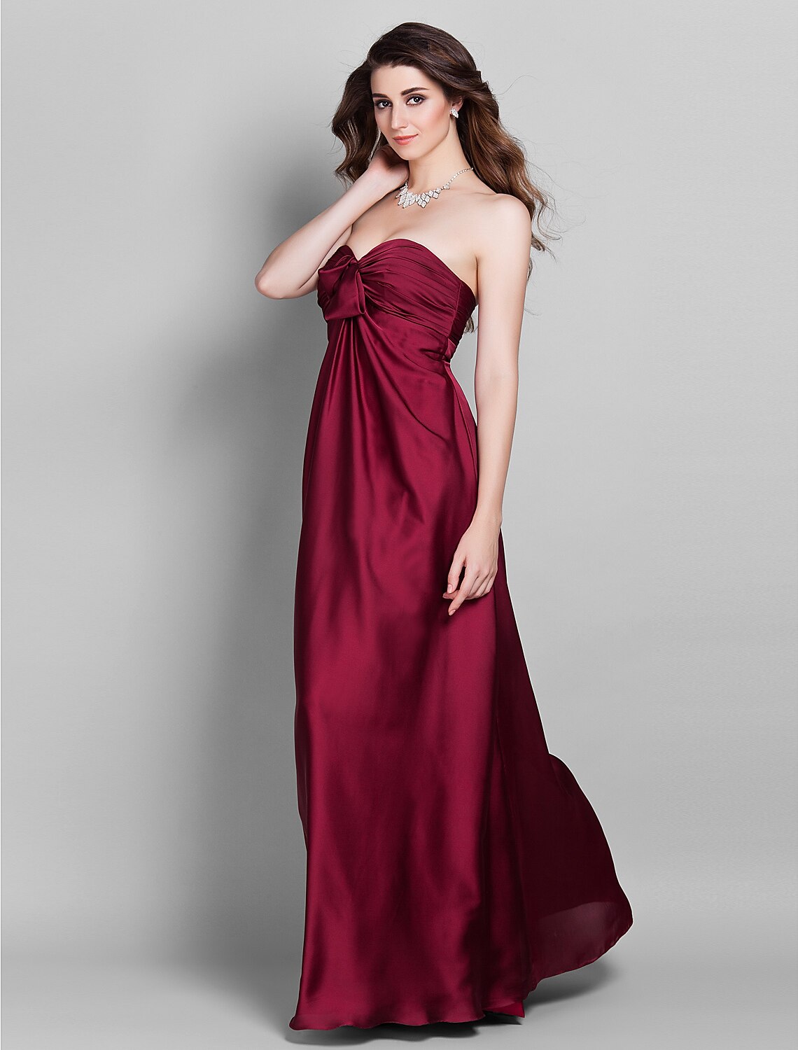 Detail of the side draping and flower accent on the elegant bridesmaid gown.