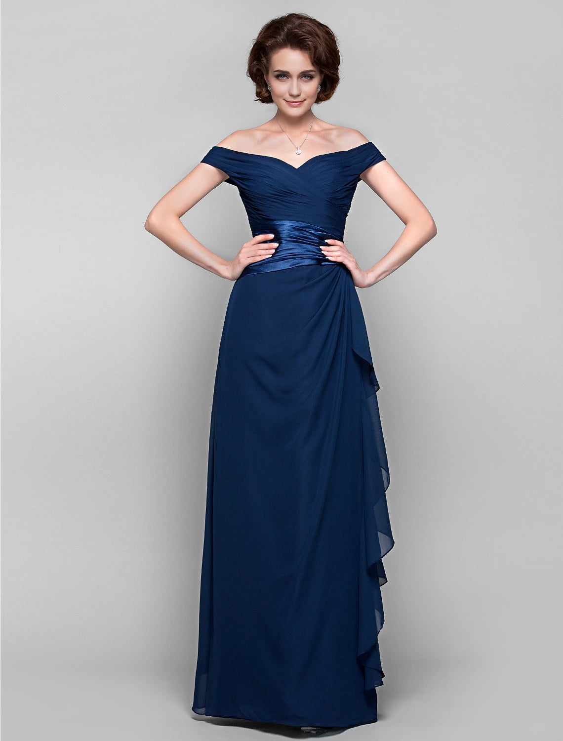 Woman wearing a dark blue off-shoulder sheath column floor-length dress with an open back.