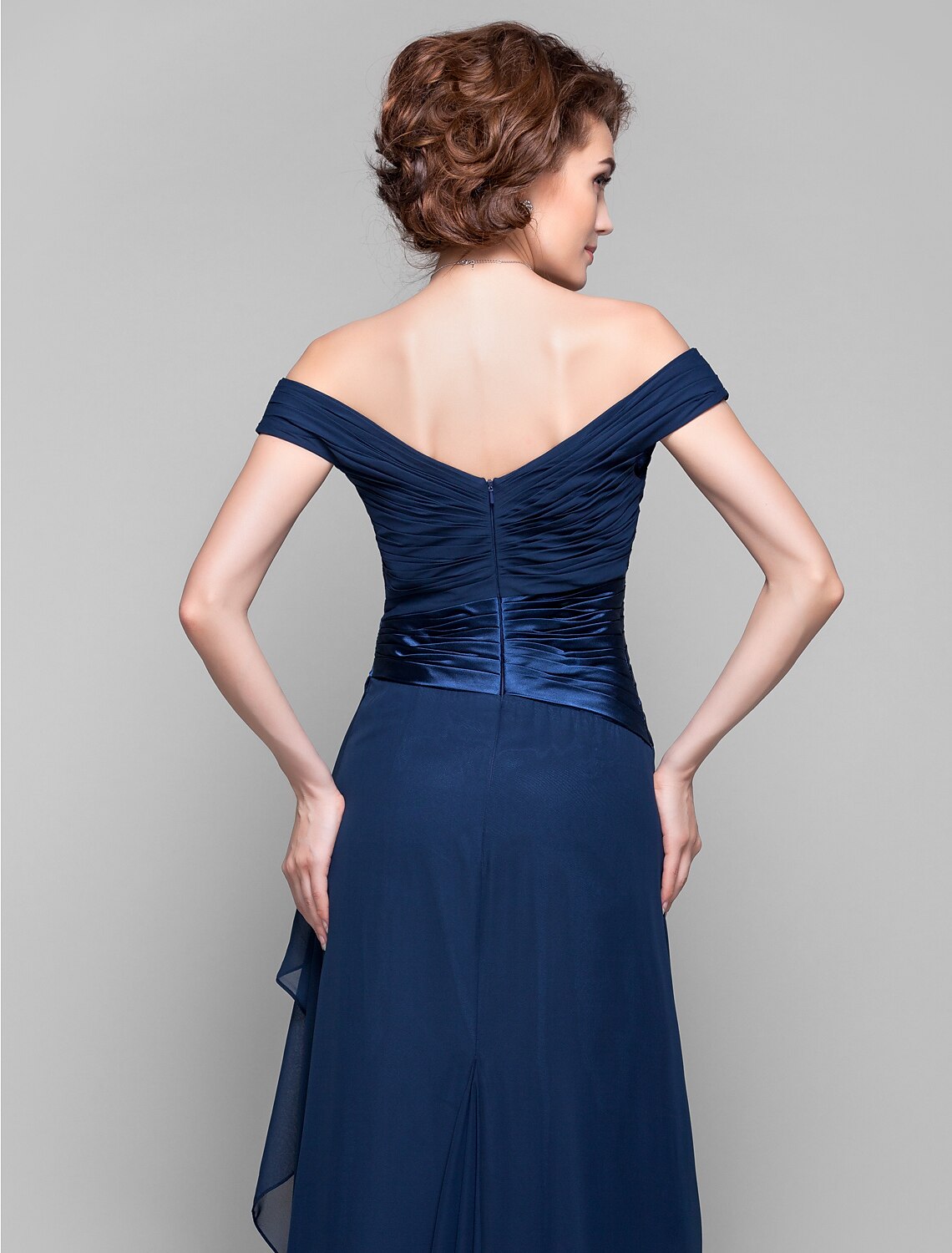 Another back view of a dark blue dress, focusing on the open back and criss-cross straps.