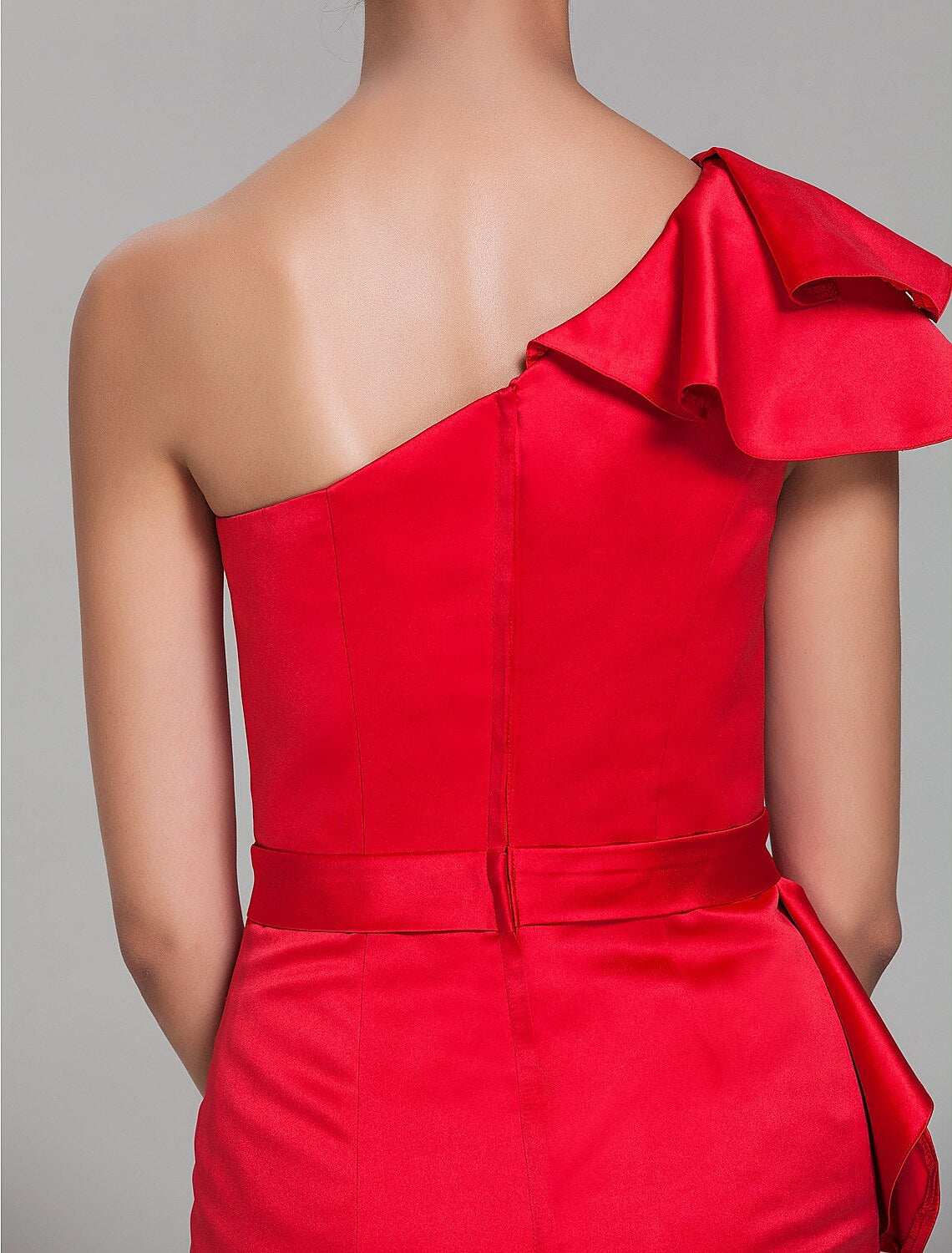 Close-up of the one-shoulder neckline and ruffle detail on the satin bridesmaid dress.