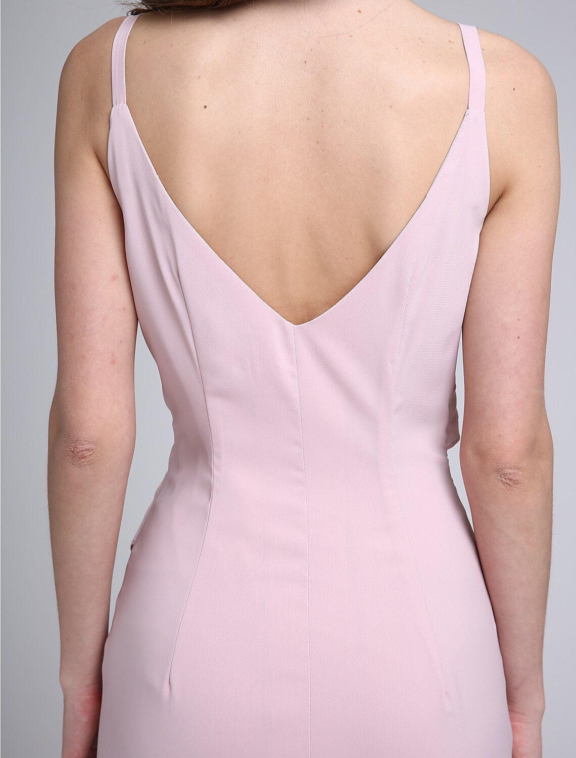 Full length view of an elegant knee-length chiffon dress.