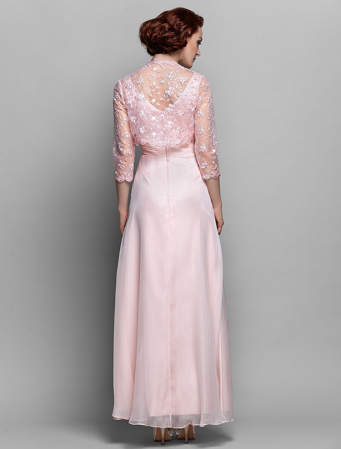 Close-up of V-neckline and delicate lace details on the dress.