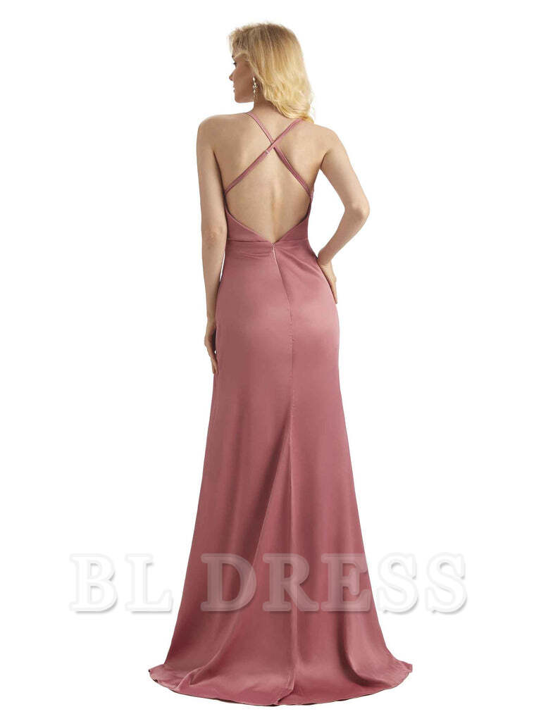 A woman posing in a satin cowl neck sheath dress, showcasing the side slit.