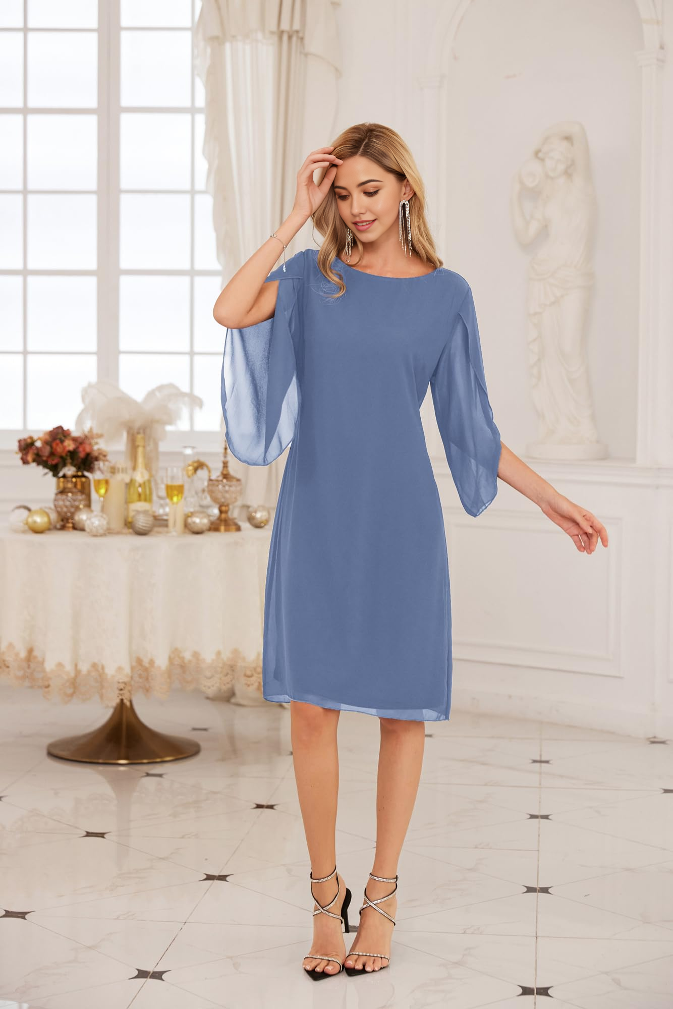 Woman wearing an elegant light blue sheath tea-length chiffon dress with a crew neck.