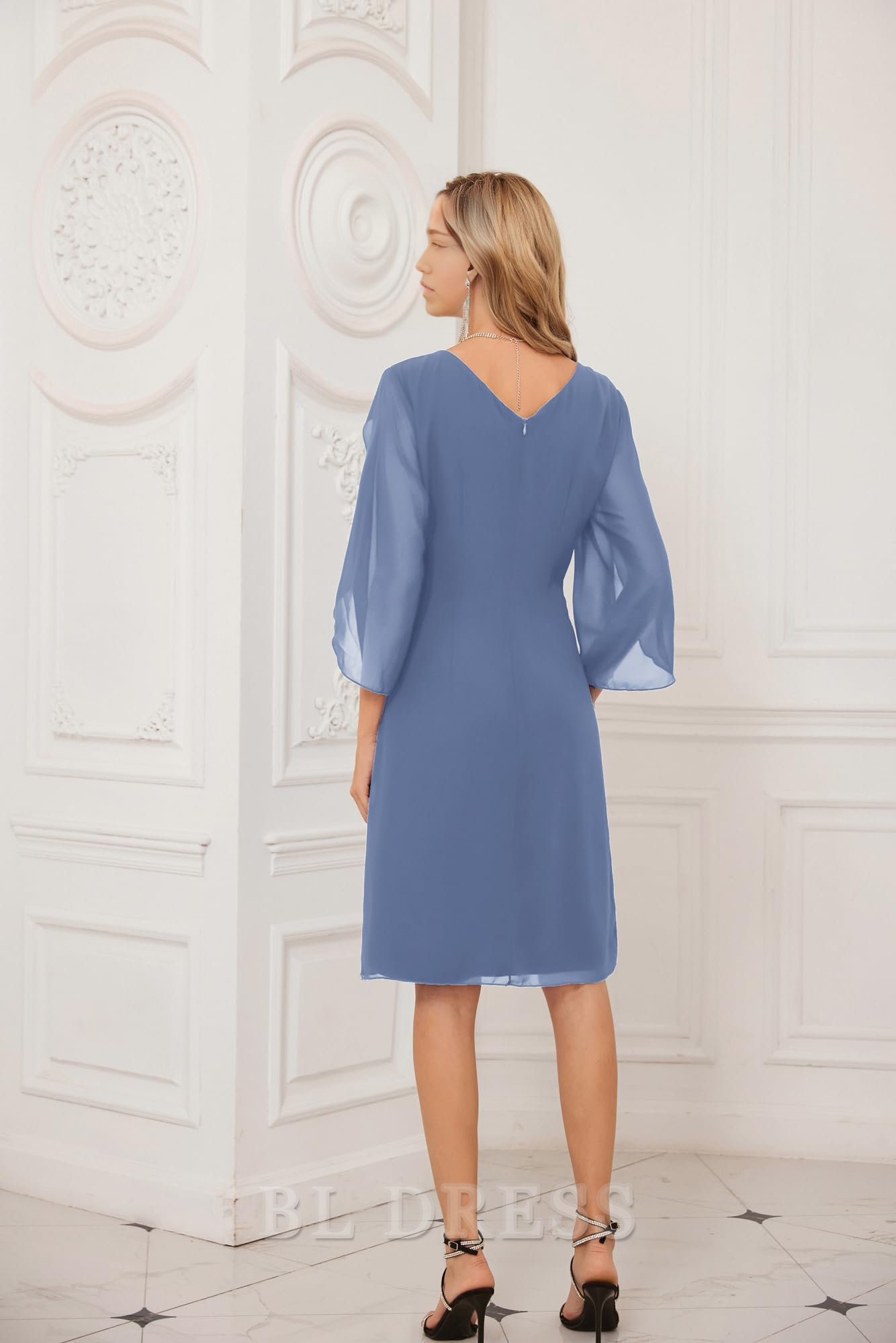 Side view of a woman in a light blue sheath tea-length formal dress.
