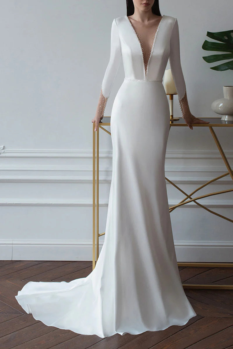 Elegant sheath wedding dress with deep V-neck and long sleeves, front view.