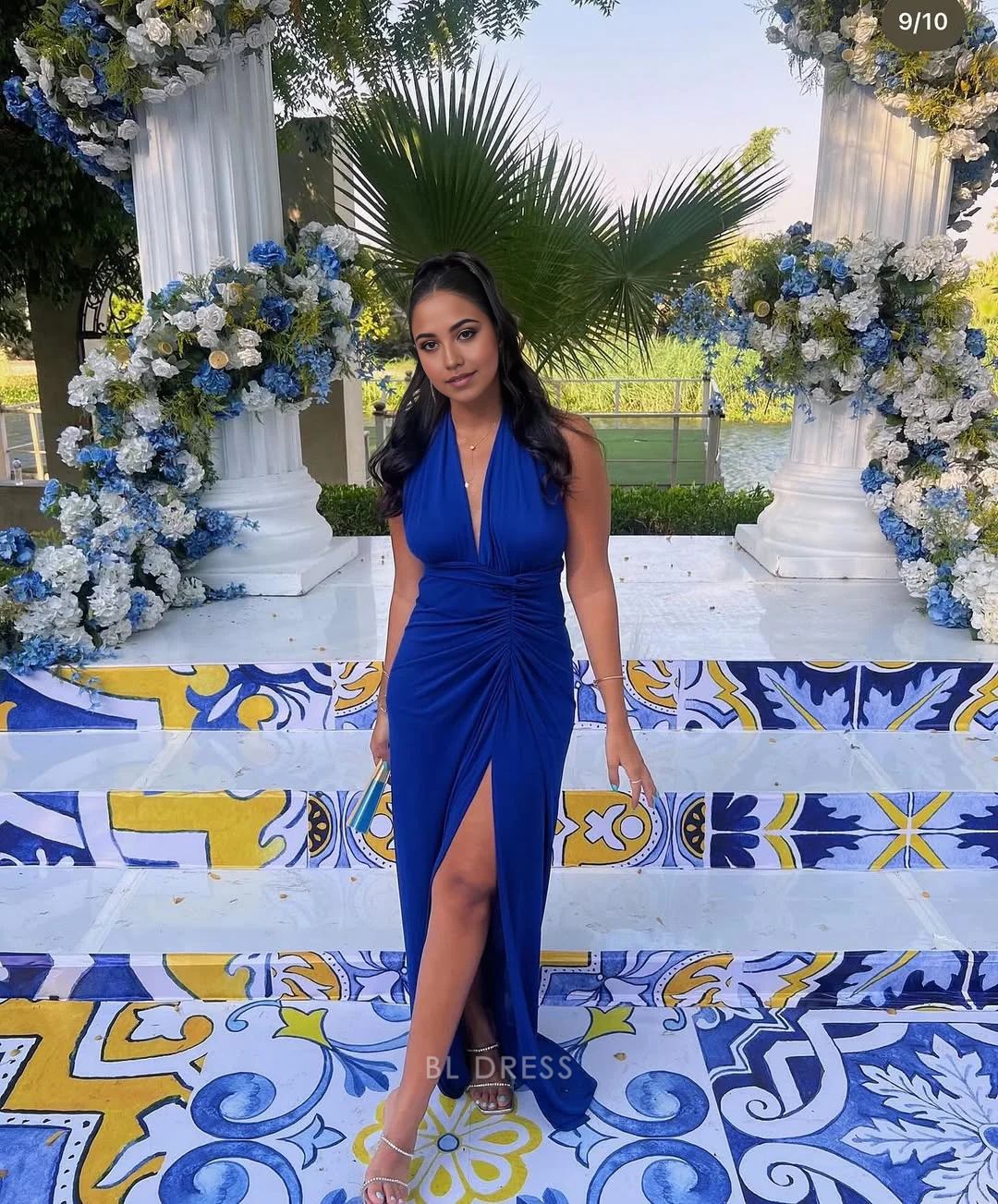 Elegant royal blue sheath dress with a deep V-neck and thigh-high slit.
