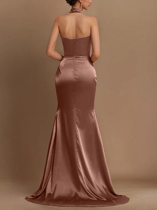 Side view of a woman wearing a sophisticated sheath prom gown.