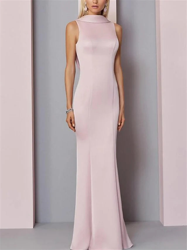 Woman wearing an elegant dark sheath floor length evening dress.