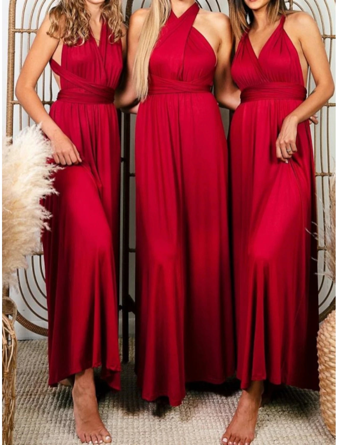 Model posing in a halter neck sheath dress.