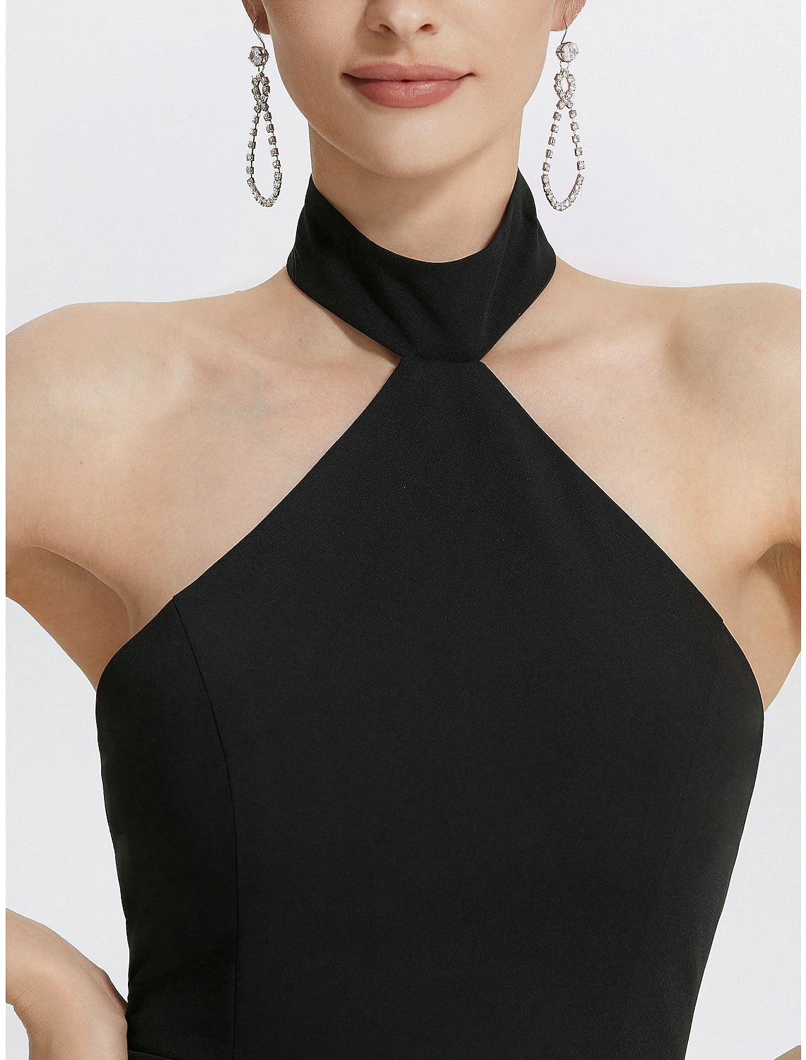 Close-up of the halter neckline and ruched bodice on the black dress.