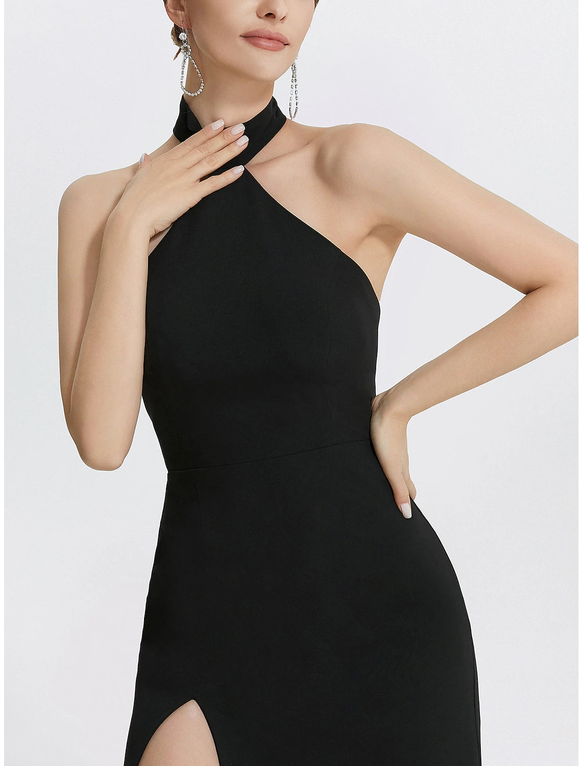 Model showcasing the flowing floor-length black evening gown.