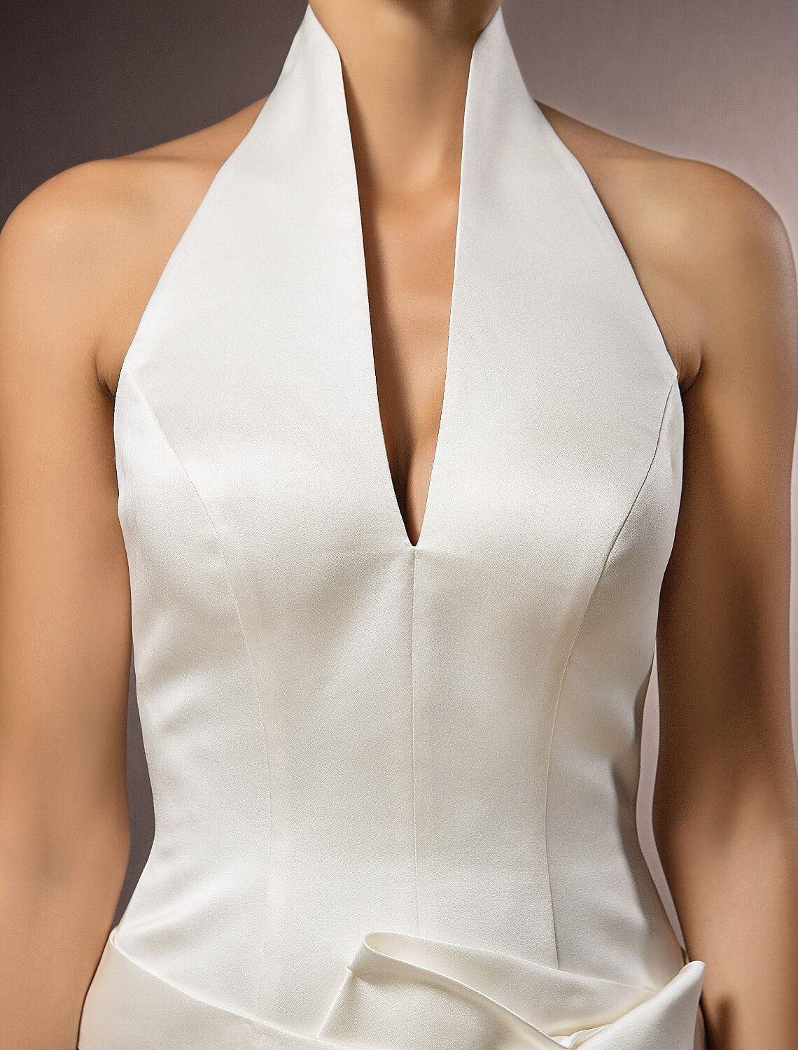 Model wearing a sleek halter neck wedding gown.