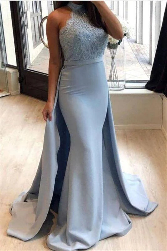 Woman wearing an elegant high-neck sleeveless lace sheath prom dress.