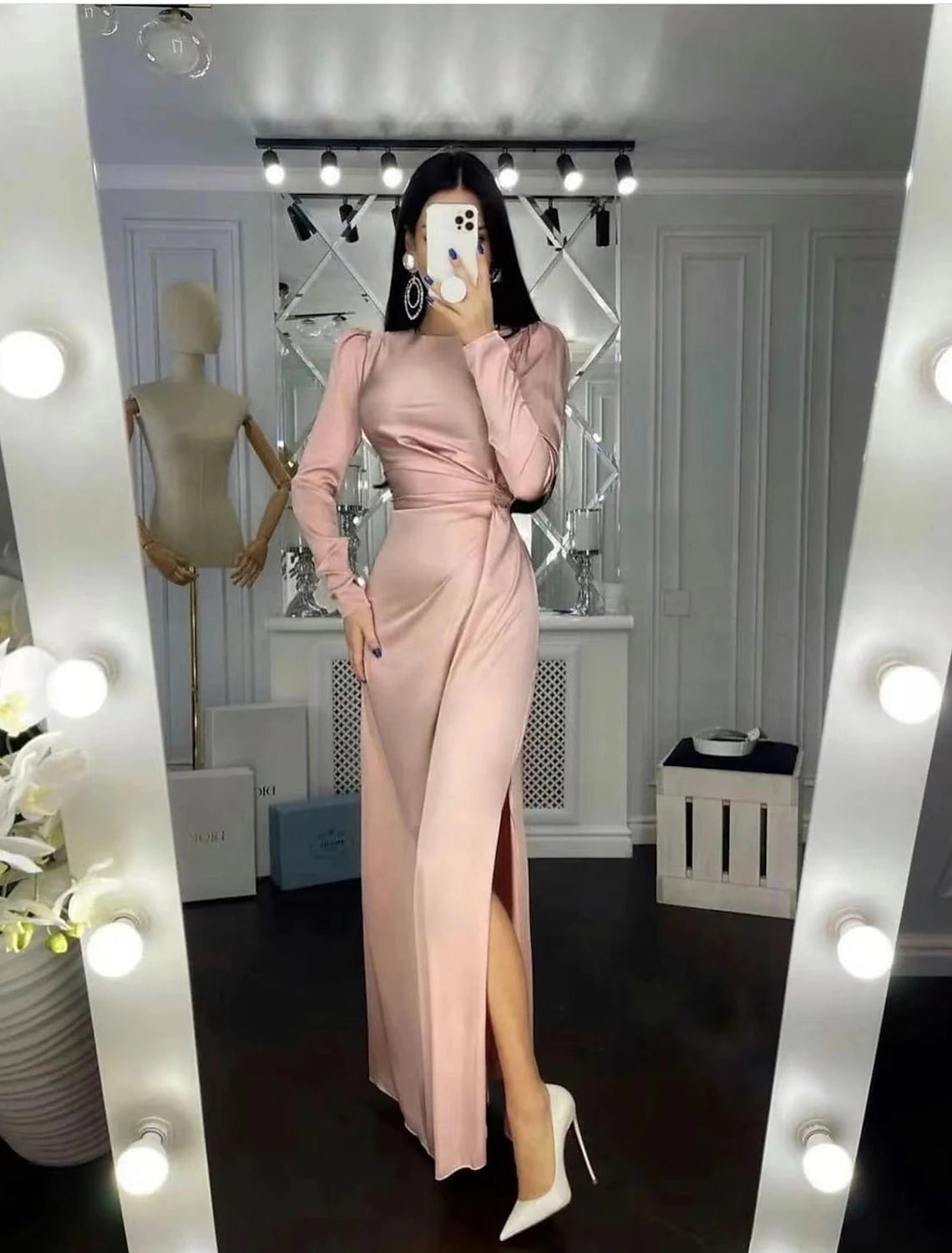 Elegant satin sheath dress with high neck and long sleeves.