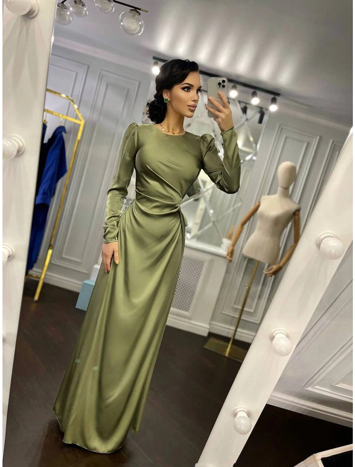 Side view of the ruched satin evening gown, highlighting the floor-length silhouette.