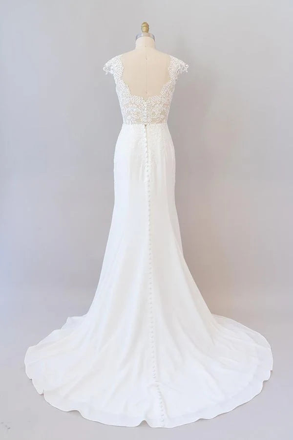 Back view of a long lace wedding gown with a delicate train.