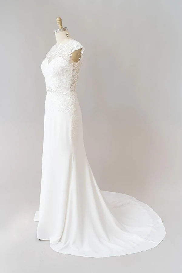 Bride wearing a romantic sheath wedding dress with V-neck.