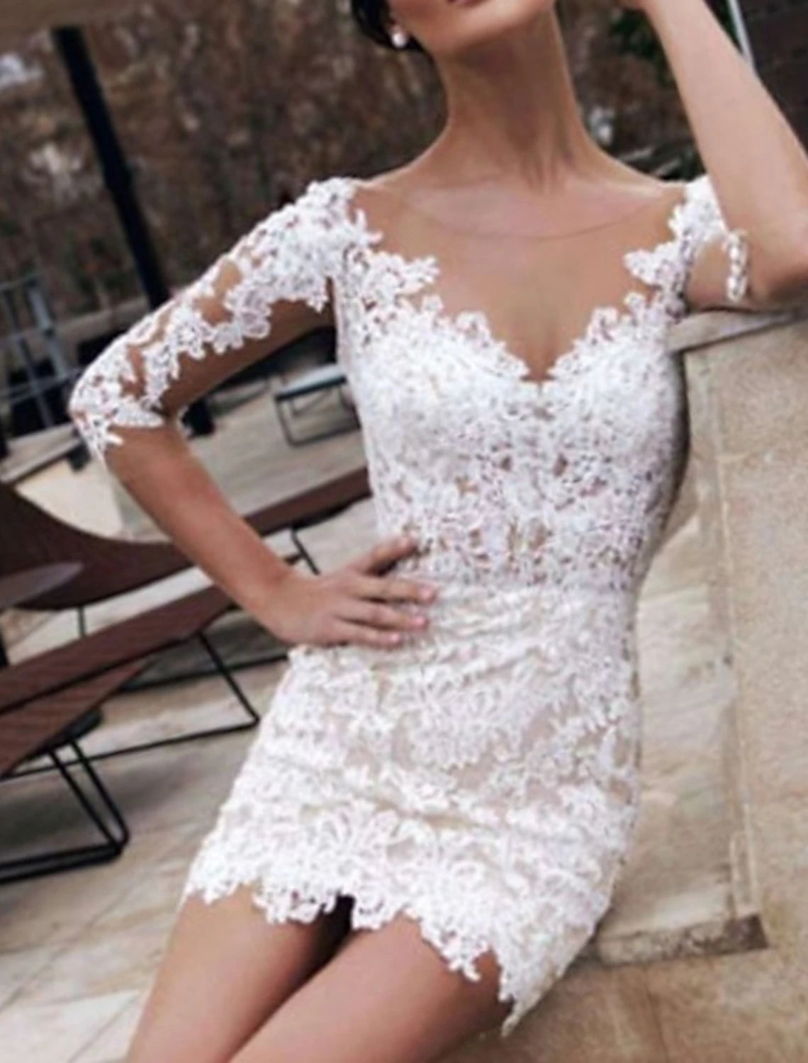 Back view of a white sheath reception dress with delicate lace appliques.