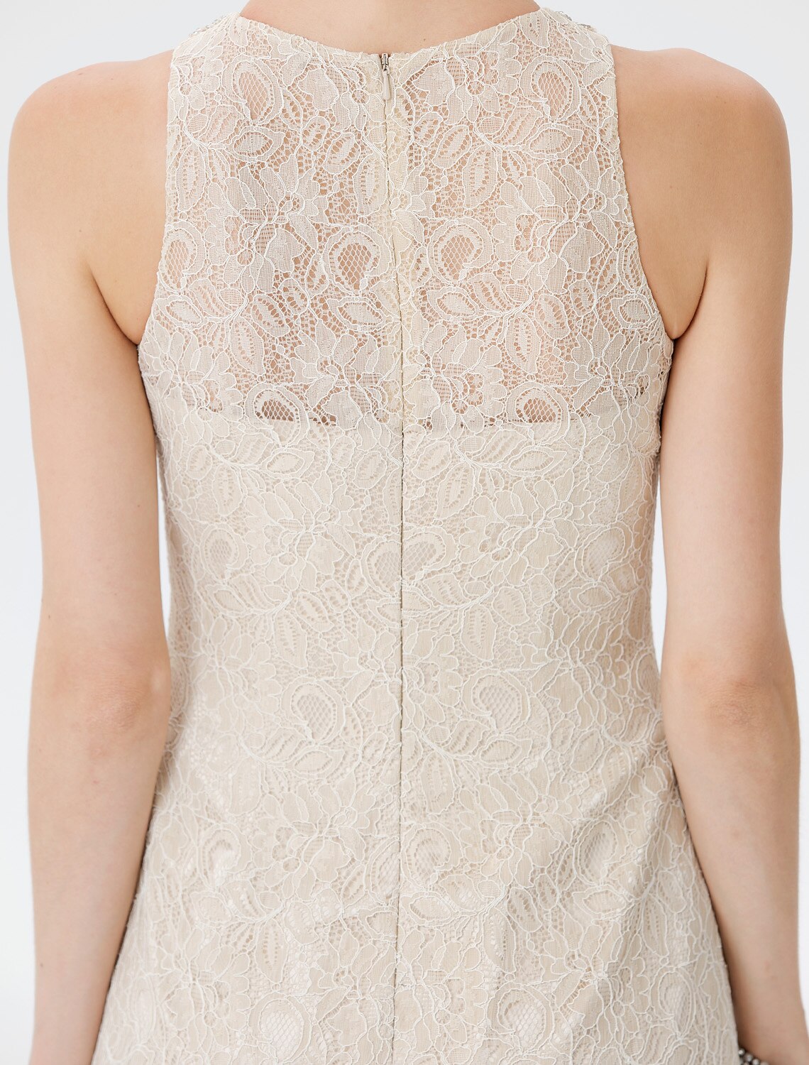 Detail of the sleeveless design and sparkling embellishments on the gown.