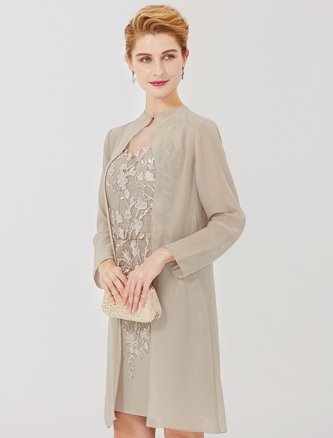 Formal dress with intricate lace appliques and illusion details.