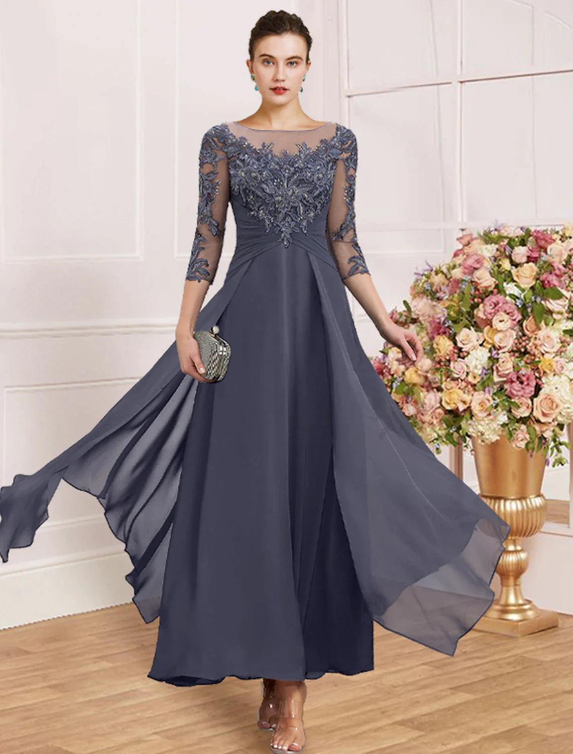 Woman in dark blue sheath dress with jewel neck and 3/4 sleeves.