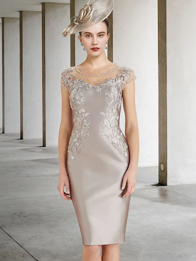 Elegant Mother of the Bride sheath dress with jewel neck, cap sleeves, lace, and beading details.