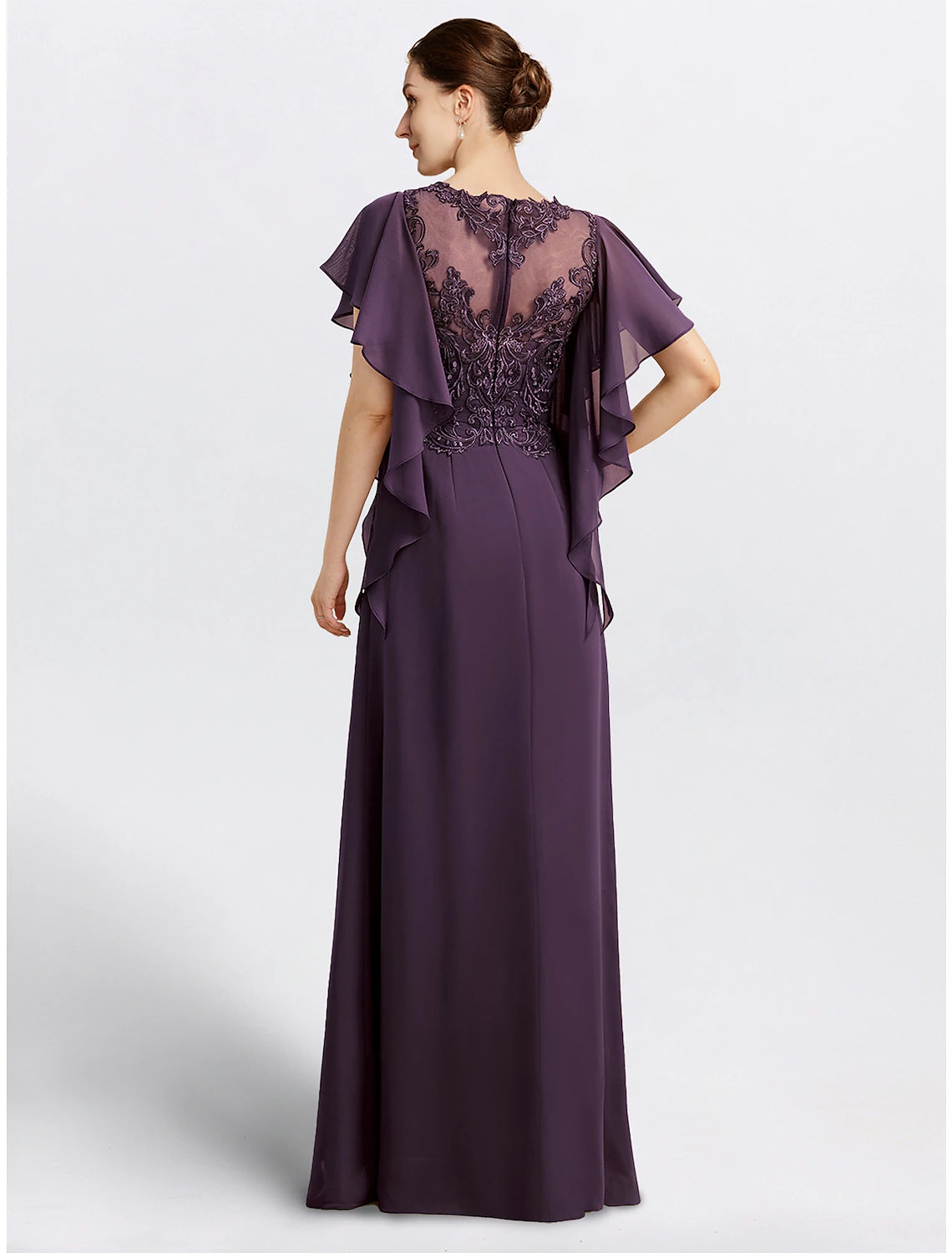 Back view of a formal chiffon cape dress with delicate beading appliques.