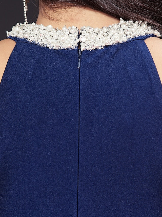 Close-up of jewel neck and pearl embellishments on the dress.