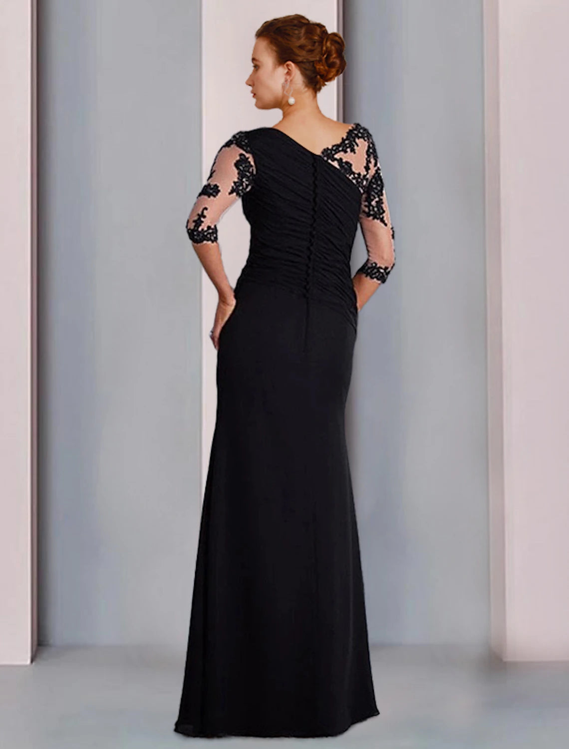 Back view of the elegant sheath dress, showcasing beading and appliques.