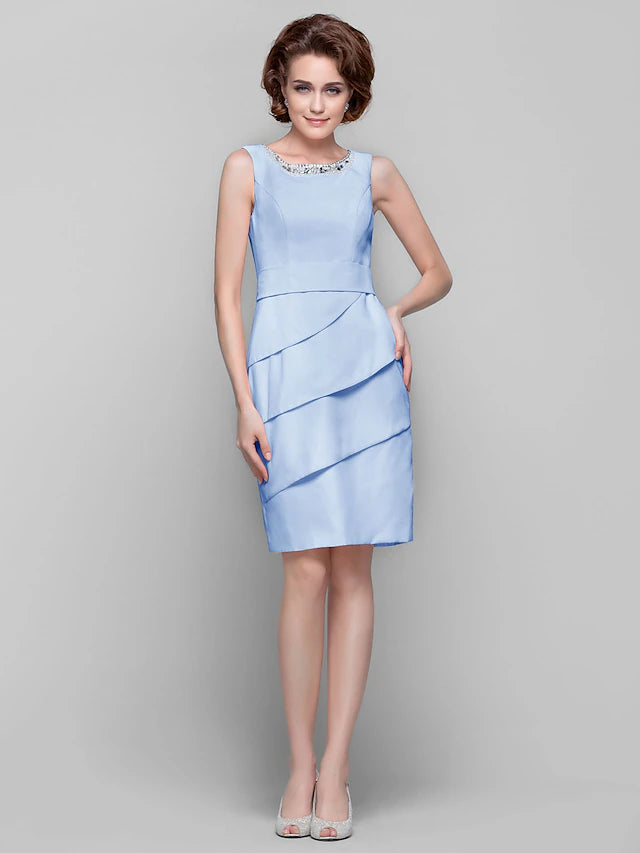 Knee-length chiffon mother of the bride dress with delicate beading.