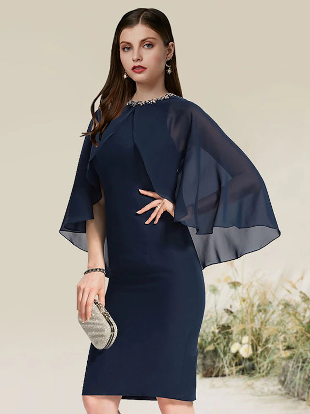 Side view of a black chiffon cocktail dress, showcasing the knee-length silhouette.