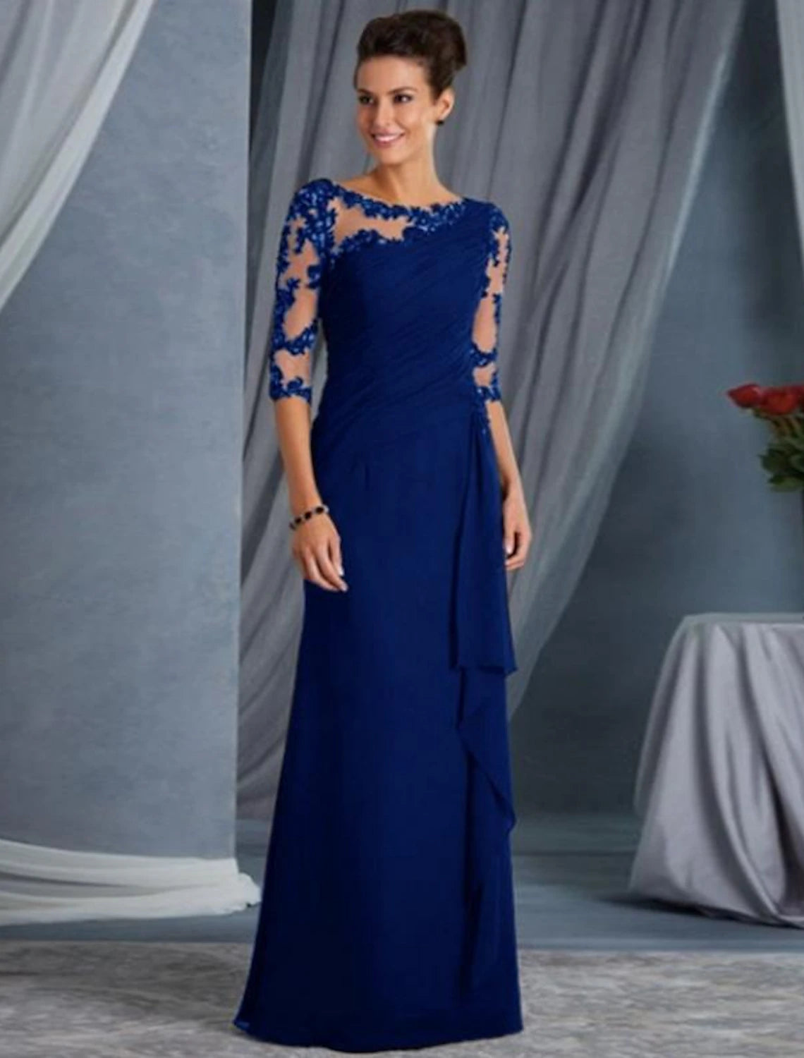 Side view of the black lace sheath gown, highlighting the half sleeves and floor-length silhouette.