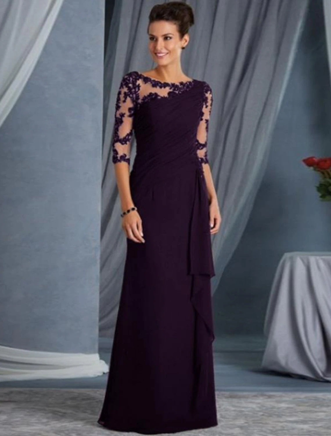 Back view of the formal black evening dress, showing the intricate lace appliques.