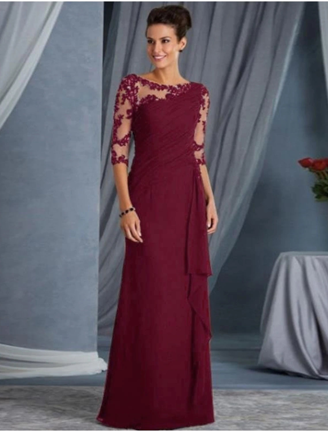 Close-up of the jewel neck and lace appliques on the half-sleeve black gown.