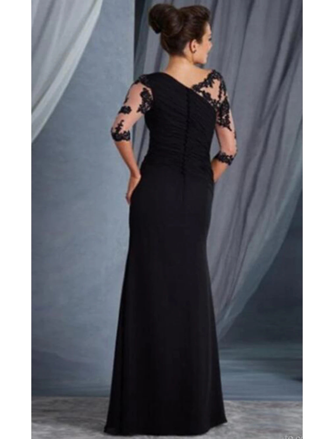 Model wearing the black sheath evening gown, showcasing its elegant drape and fit.