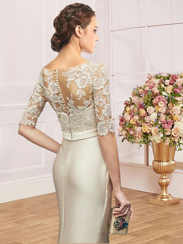 Sophisticated satin and lace sheath dress with half sleeves and jewel neckline.