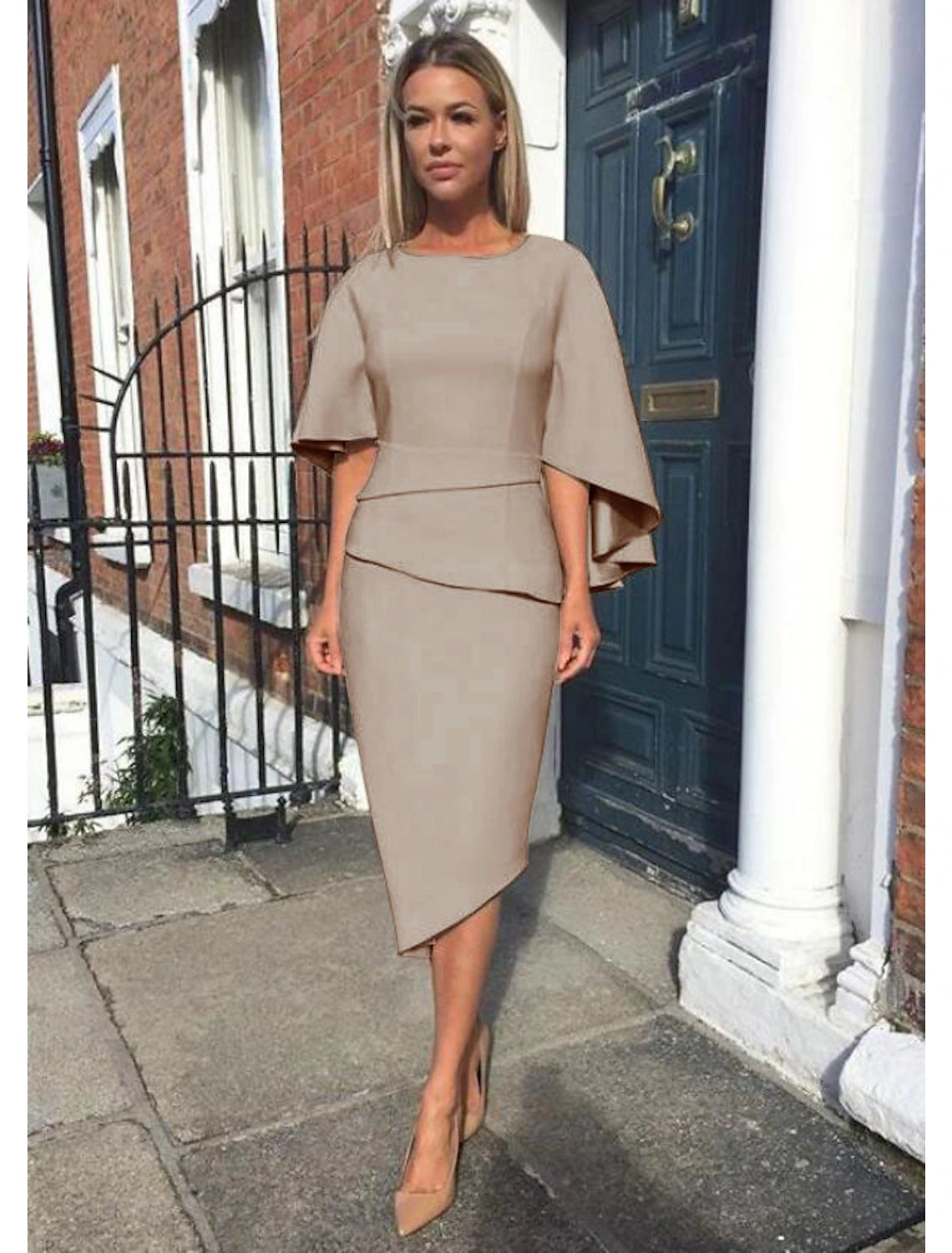 Back view of the knee-length tiered sheath dress.
