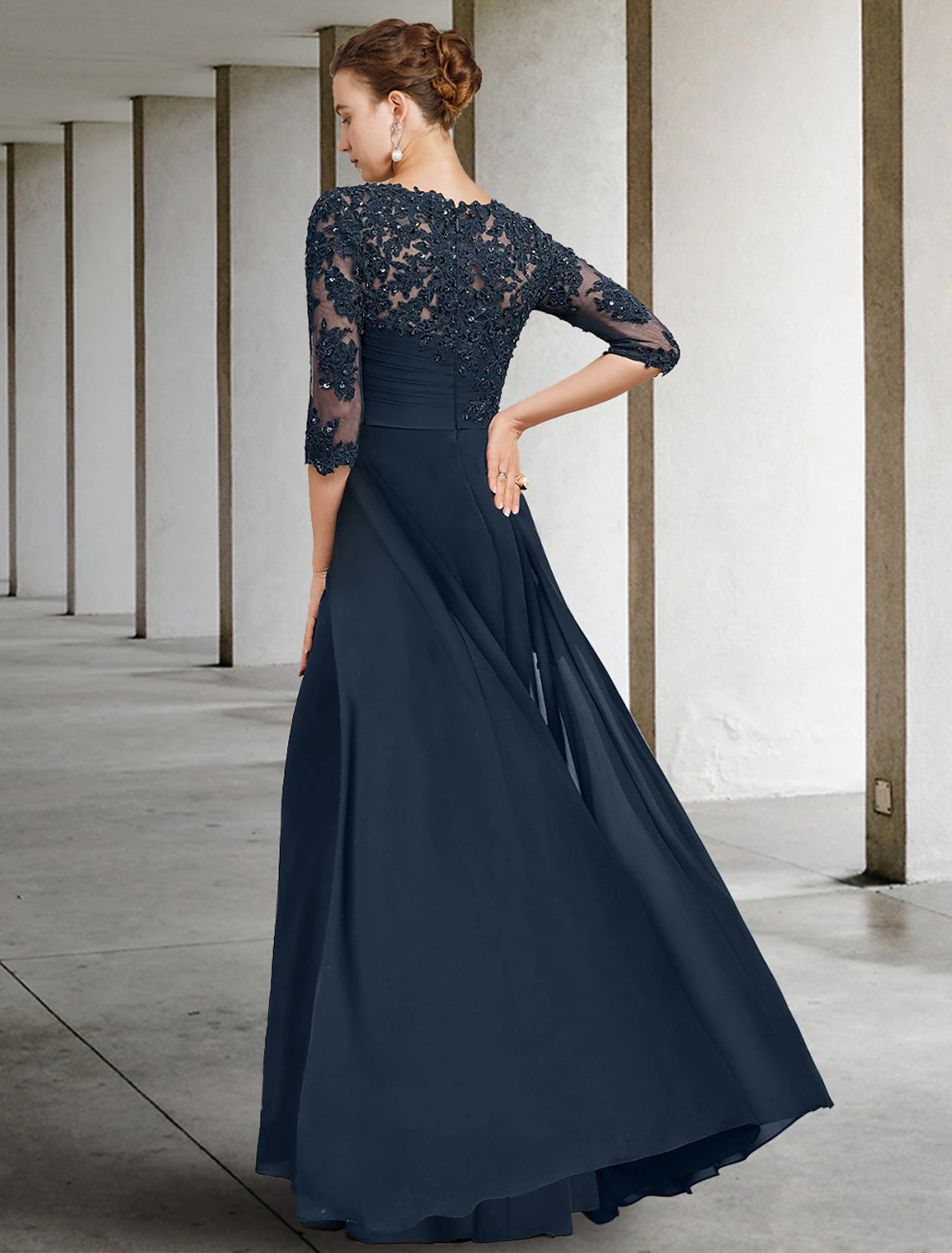 Back view of the floor-length chiffon lace dress with sequin ruching.