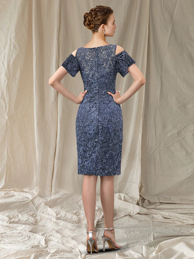 Back view of the knee-length sheath dress, showcasing lace details and column silhouette.